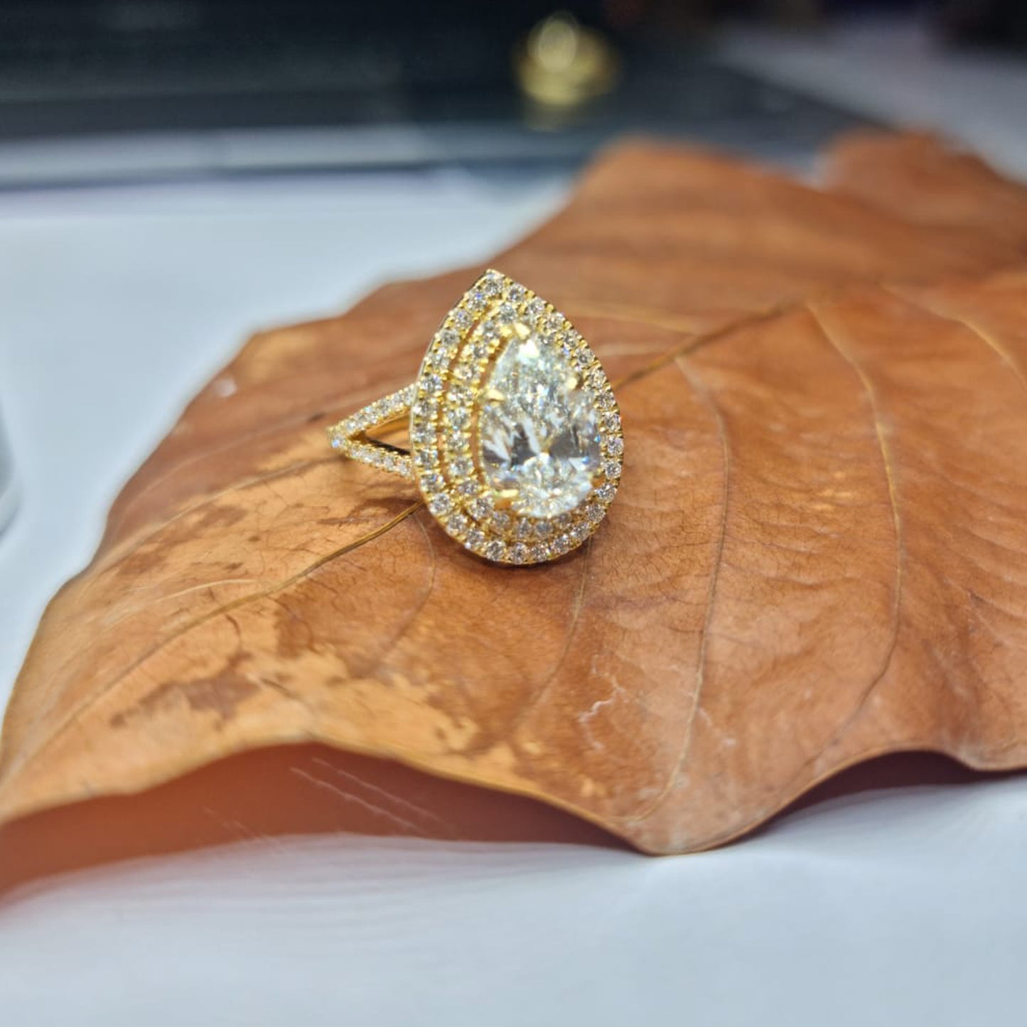 Pear-cut Yellow Diamond Halo Engagement Ring in Platinum